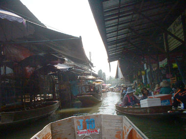 Boat through floating market