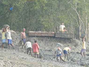 People from village carrying mud